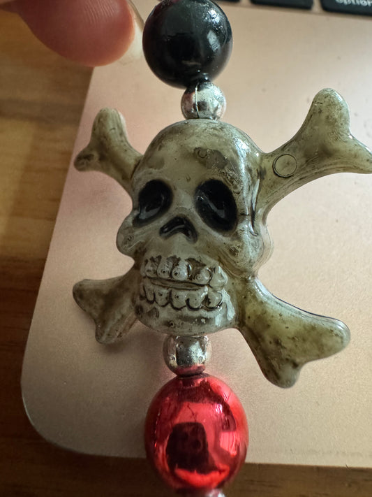 Grey skull and crossbones black and red bead